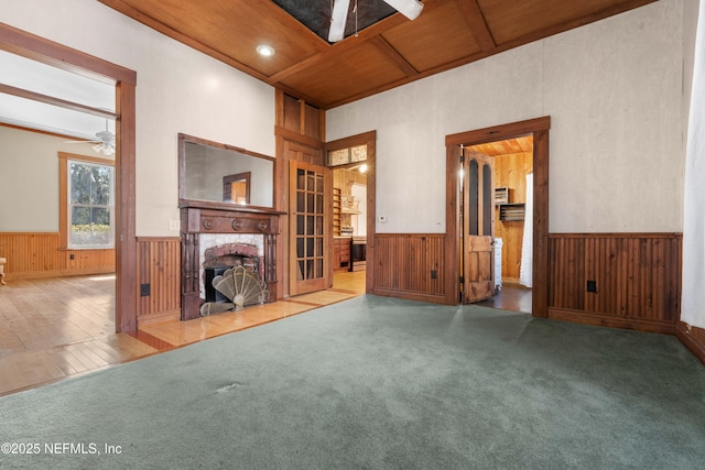 unfurnished living room with coffered ceiling, wood ceiling, ceiling fan, a brick fireplace, and beam ceiling