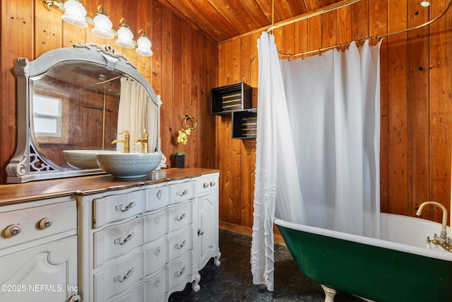 bathroom with a tub, wooden ceiling, vanity, and wood walls