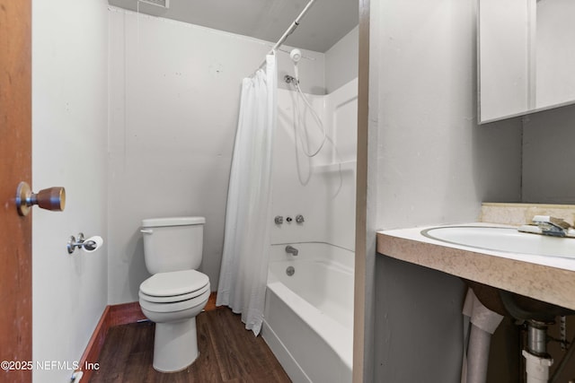 bathroom with hardwood / wood-style flooring, shower / bath combo, and toilet