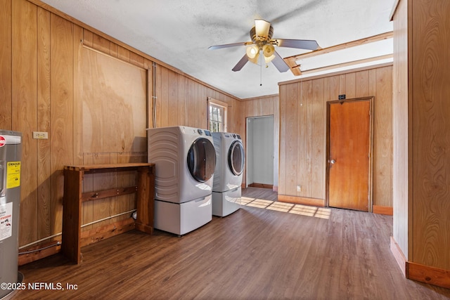 laundry room featuring washer and dryer, wood-type flooring, ceiling fan, electric water heater, and a textured ceiling