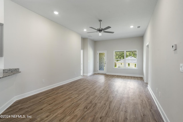 unfurnished living room featuring wood-type flooring and ceiling fan