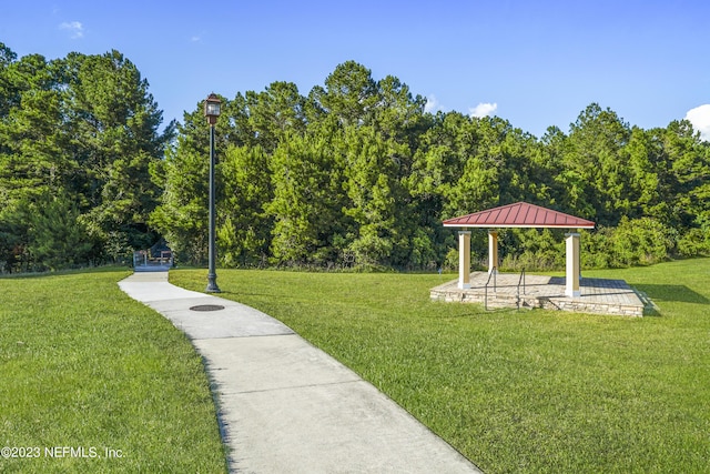 view of property's community featuring a yard and a gazebo