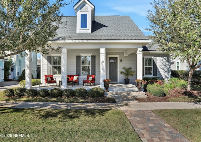 view of front facade with covered porch and a front lawn