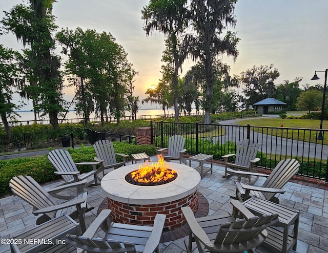 patio terrace at dusk featuring a fire pit