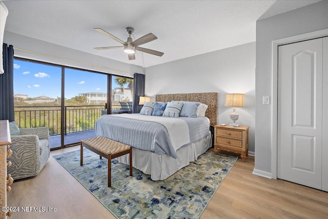 bedroom featuring a textured ceiling, access to outside, light hardwood / wood-style flooring, and ceiling fan