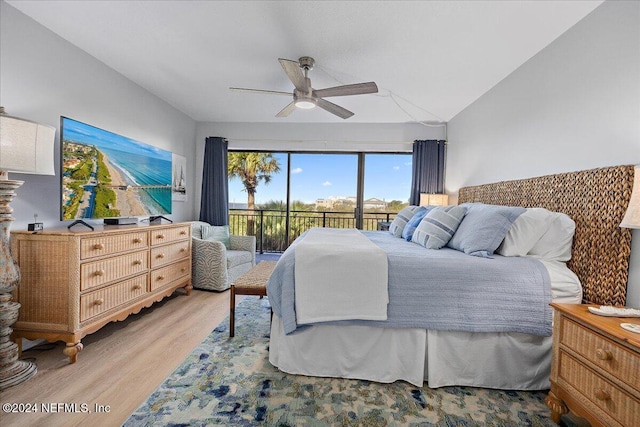 bedroom with access to outside, light hardwood / wood-style floors, ceiling fan, and lofted ceiling