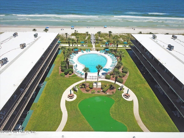 birds eye view of property with a beach view and a water view