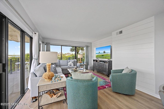 7870 A1A S Unit 209, Saint Augustine, FL 32080 - living area featuring plenty of natural light, wood finished floors, and wood walls