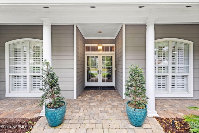 doorway to property with a porch and french doors