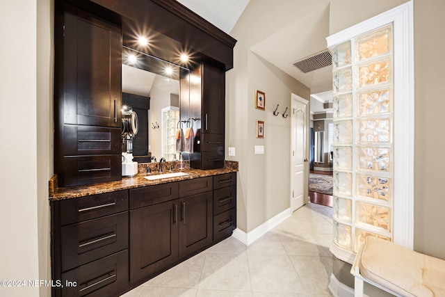 bathroom with tile patterned floors, visible vents, vanity, and baseboards