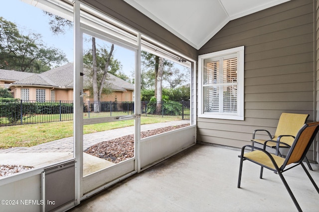 sunroom with a healthy amount of sunlight and vaulted ceiling