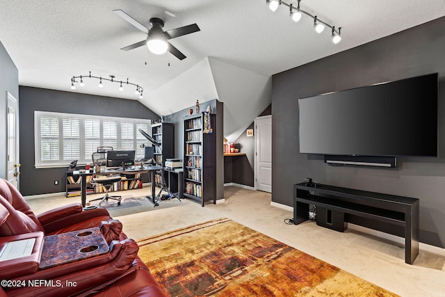 carpeted office with baseboards, a textured ceiling, ceiling fan, and vaulted ceiling