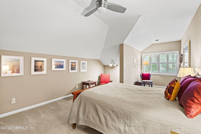 carpeted bedroom featuring baseboards, lofted ceiling, and a ceiling fan