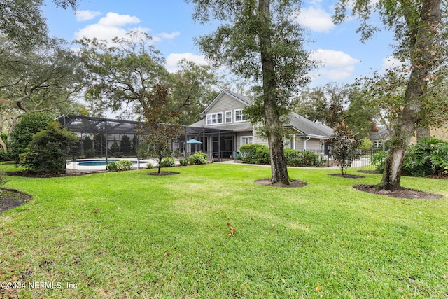 view of yard featuring glass enclosure and an outdoor pool