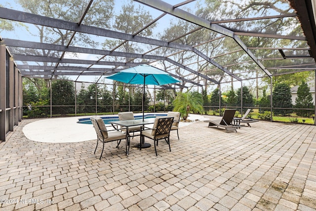 view of patio featuring a lanai and an outdoor pool