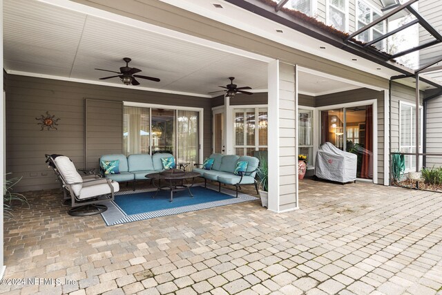 view of patio / terrace with ceiling fan, a lanai, and an outdoor hangout area