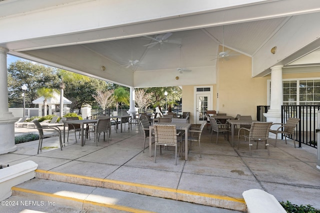 view of patio / terrace with ceiling fan, outdoor dining space, and fence