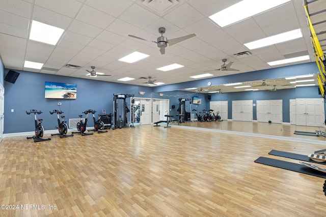 workout area featuring visible vents, baseboards, and wood finished floors