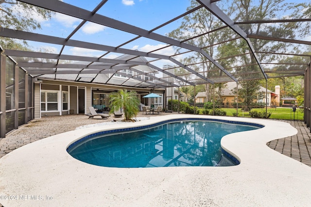 pool featuring a lanai and a patio area