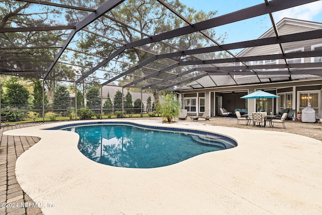 outdoor pool with a patio, a ceiling fan, and a lanai