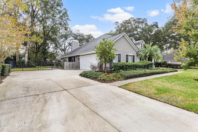 view of side of property with a lawn and a garage