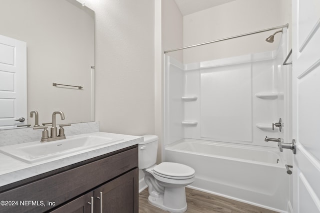 full bathroom with shower / tub combination, vanity, hardwood / wood-style flooring, and toilet