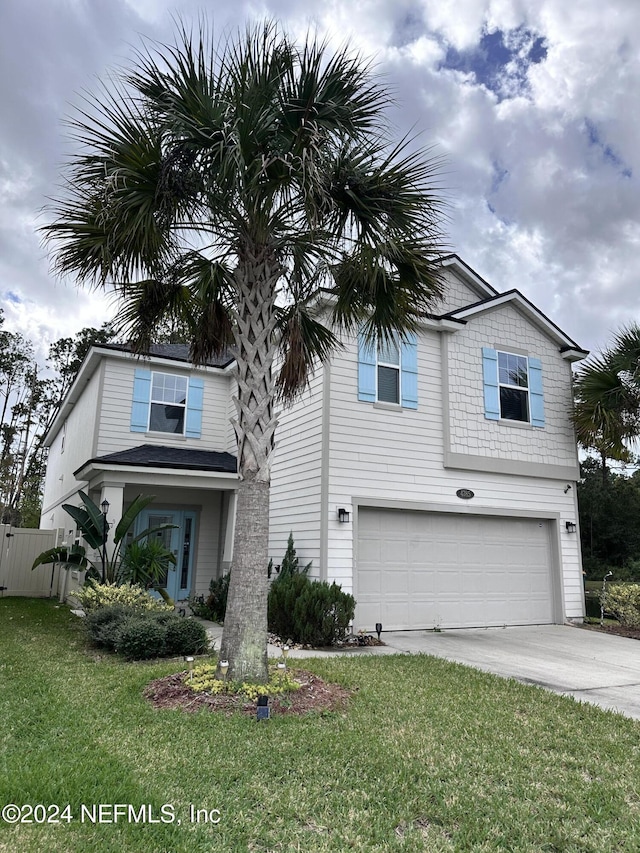 view of front of house featuring a garage and a front yard