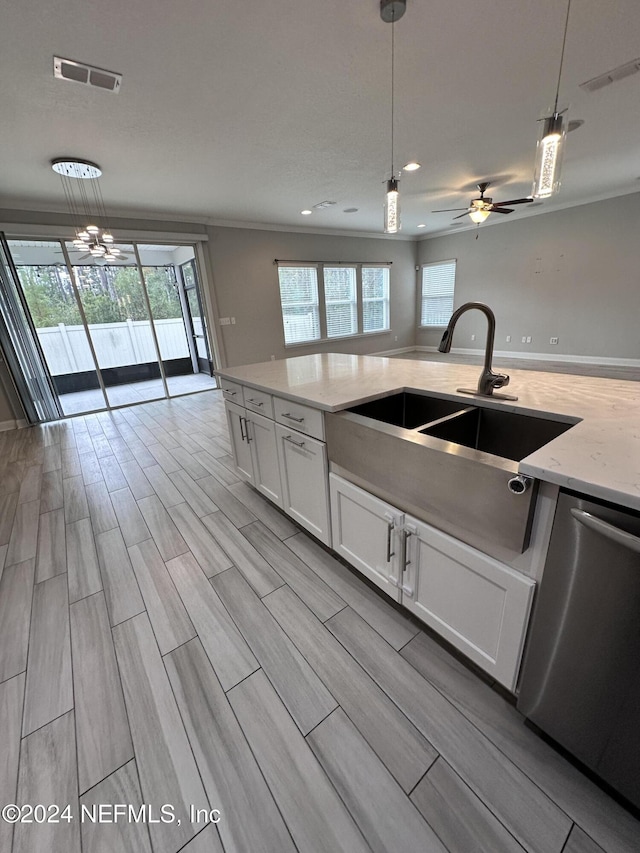 kitchen with white cabinets, sink, light hardwood / wood-style flooring, dishwasher, and hanging light fixtures