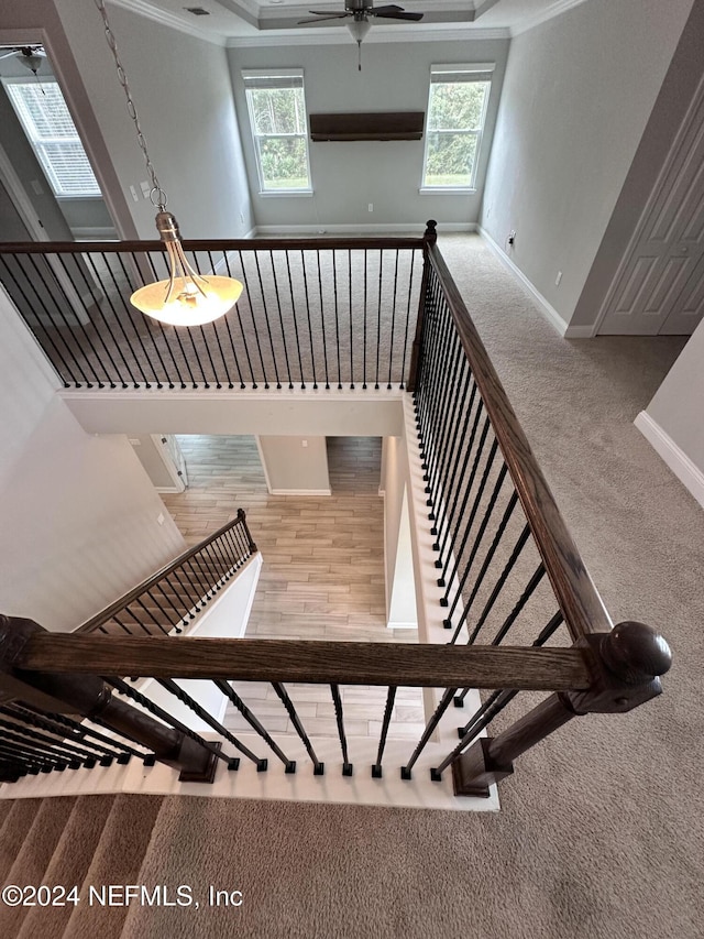 staircase with crown molding, carpet, and a healthy amount of sunlight