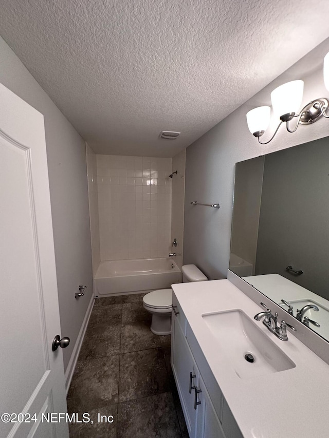 full bathroom with tile patterned floors, a textured ceiling, toilet, vanity, and tiled shower / bath