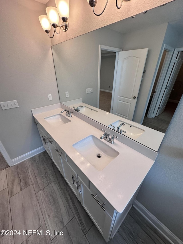 bathroom featuring vanity and a chandelier