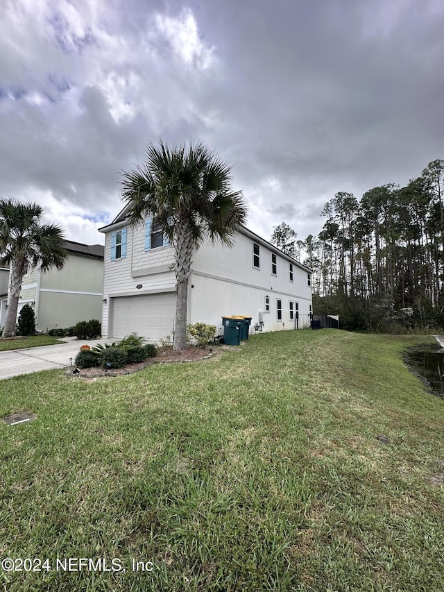 view of home's exterior featuring a garage and a lawn