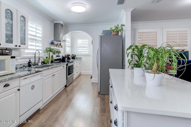 kitchen featuring plenty of natural light, white cabinetry, sink, and appliances with stainless steel finishes