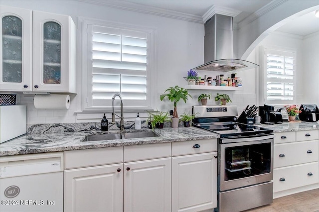 kitchen with backsplash, wall chimney exhaust hood, sink, white cabinets, and stainless steel electric range