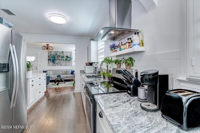 kitchen with white cabinets, appliances with stainless steel finishes, and a wealth of natural light