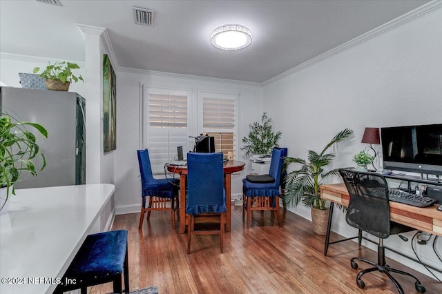 office space with wood-type flooring and crown molding