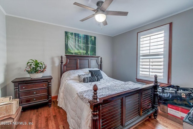 bedroom with ceiling fan, dark wood-type flooring, and ornamental molding