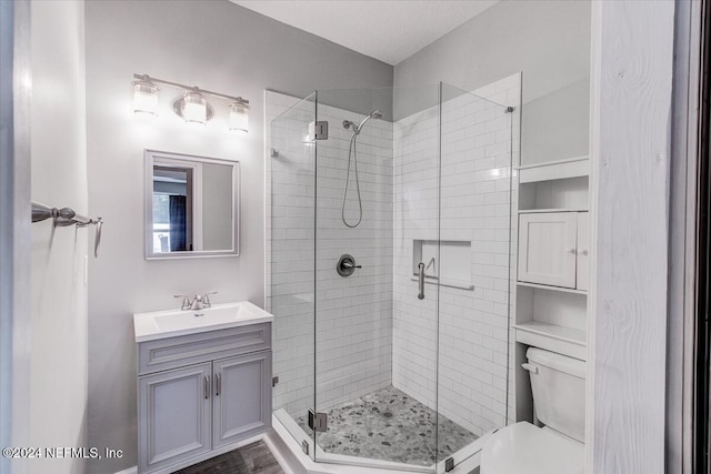 bathroom featuring hardwood / wood-style floors, vanity, toilet, and an enclosed shower