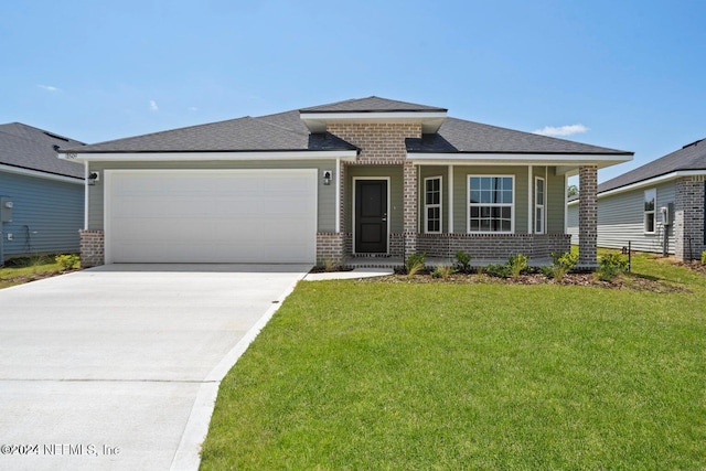 prairie-style house with a garage and a front lawn