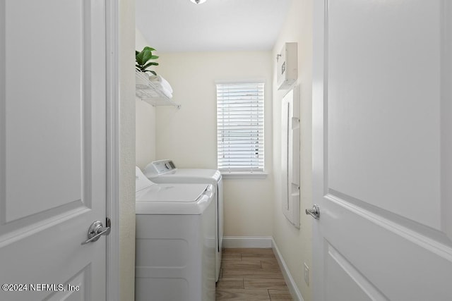 laundry room featuring independent washer and dryer and hardwood / wood-style flooring