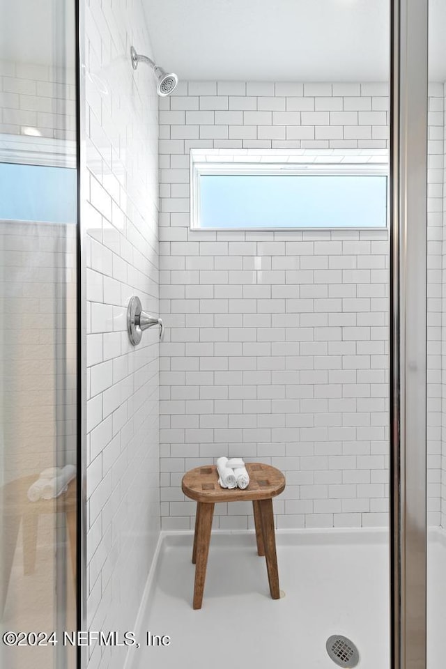 bathroom featuring a shower with shower door