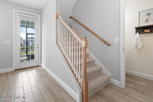 stairway featuring hardwood / wood-style flooring