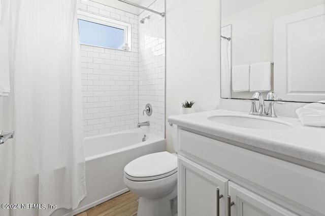 full bathroom featuring toilet, vanity, shower / bath combination with curtain, and hardwood / wood-style flooring