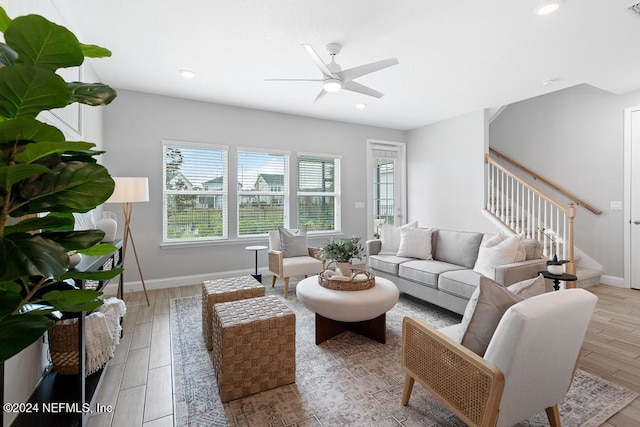 living room featuring light hardwood / wood-style flooring and ceiling fan