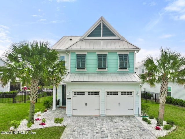 view of front of home featuring a front yard and a garage