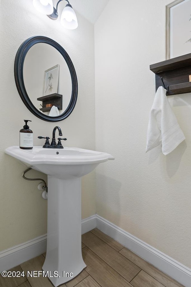 bathroom with hardwood / wood-style flooring and sink