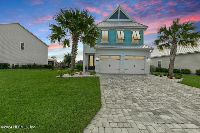 view of front of house featuring a yard and a garage