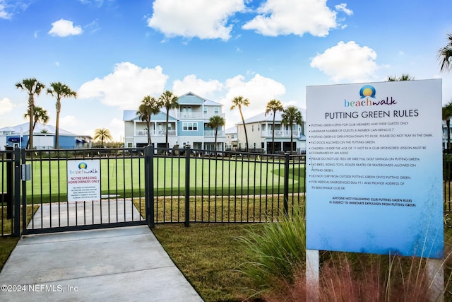 view of gate featuring a lawn