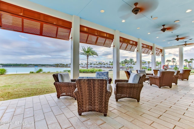 view of patio featuring ceiling fan and a water view