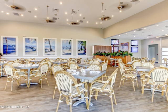 dining space featuring light wood-type flooring and ceiling fan